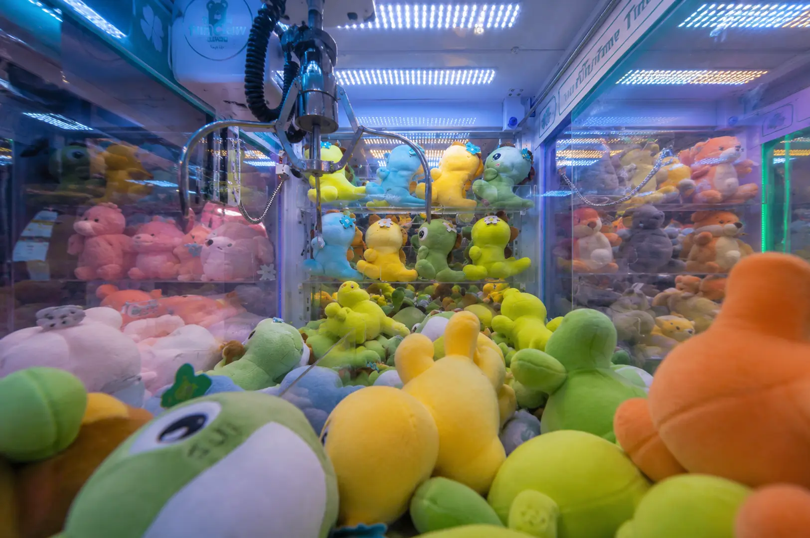 Colorful plush toys filling a claw machine arcade game