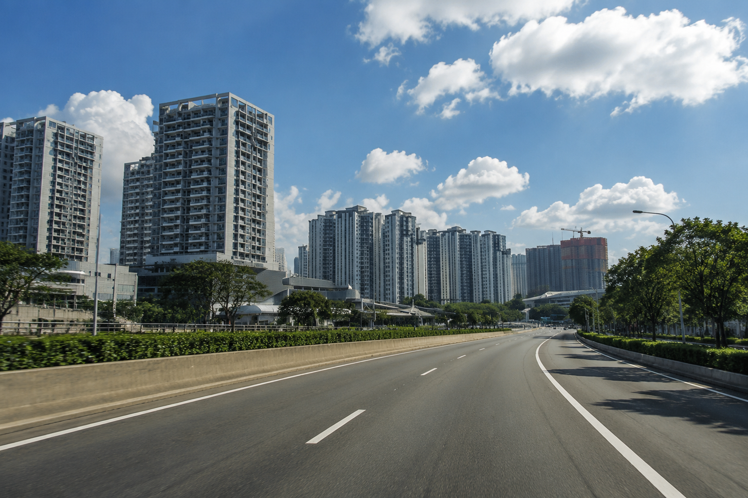 Wide road framed by high-rise buildings in Woodlands
