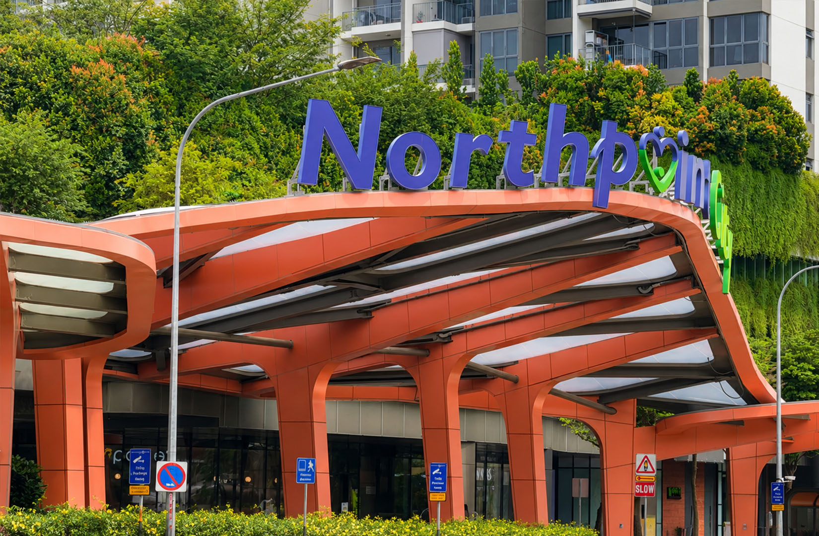 Northpoint City entrance in Yishun, Singapore, showing the mall’s modern exterior surrounded by greenery and residential buildings.