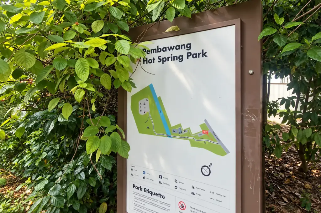 Sembawang Hot Spring Park entrance sign surrounded by lush tropical greenery.